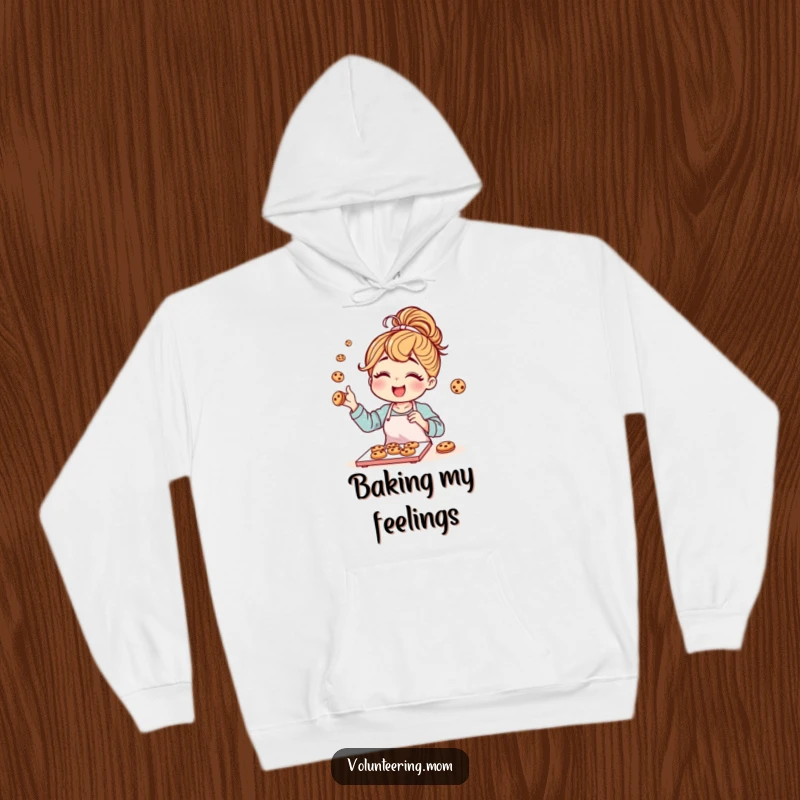 Funny mom character with a messy bun joyfully baking cookies, featured on a cozy hoodie.